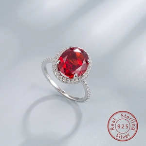 Macro shot of 925 sterling silver ring with oval red gemstone and S925 engraving