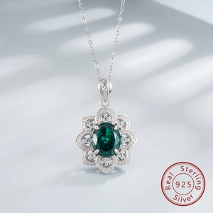 Detail of 925 sterling silver lotus necklace featuring emerald green oval carbon diamond
