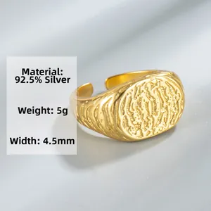 Detail of 925 sterling silver ring featuring molten lava texture and gold plated finish