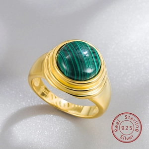 Macro shot of S925 sterling silver stamp on the inner band of a gold malachite ring