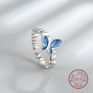 Detail view of S925 silver ring featuring blue gradient enamel butterfly and geometric band