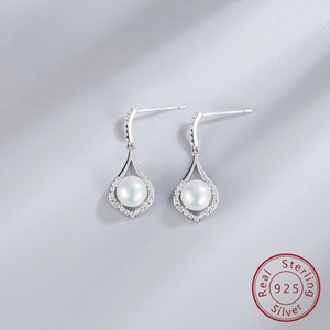 Macro shot of S925 sterling silver teardrop earrings with white freshwater pearls