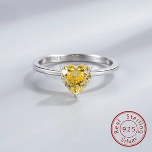 Close-up of S925 sterling silver ring featuring a heart-shaped yellow gemstone detail