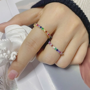 Macro detail of rainbow zircon S925 silver rings worn by a model in warm natural light