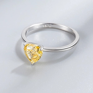 Macro shot of S925 sterling silver stamp and heart-shaped yellow gemstone on the ring band
