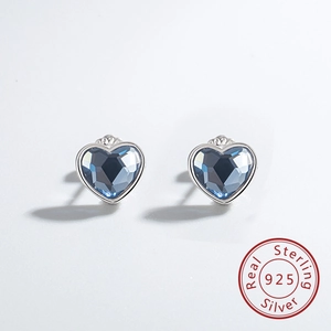 Detailed macro view of S925 sterling silver heart-shaped blue crystal stud earrings