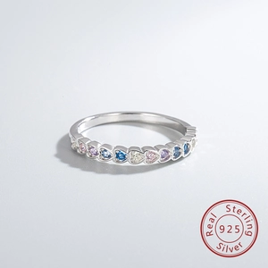Macro detail of 925 sterling silver ring with colorful heart-shaped cubic zirconia stones