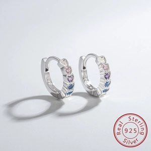 Close-up of S925 sterling silver hoop earrings with gradient pink, purple, and blue heart stones