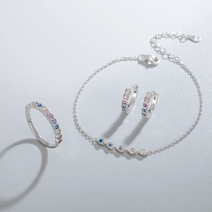 S925 sterling silver jewelry set with colorful heart-shaped zircons on gray surface
