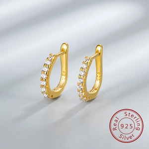 Macro shot of gold-plated S925 sterling silver hoop earrings with white zircon accents