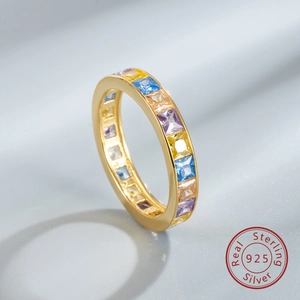 Macro shot of S925 gold-plated eternity ring with square-cut rainbow cubic zirconia