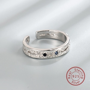 Macro shot of S925 sterling silver hammered texture ring with blue and black zircon stones
