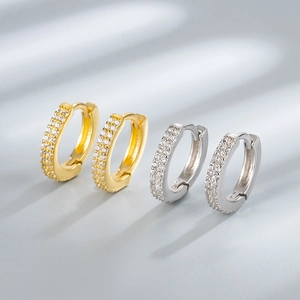Macro detail of luxury gold and silver S925 sterling silver hoop earrings with zircon pavé