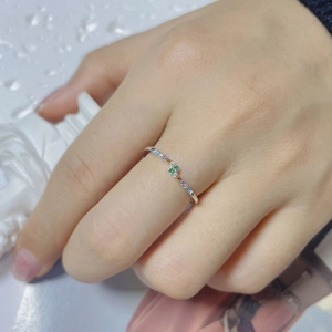Close-up of a slim S925 sterling silver ring with colorful rainbow cubic zirconia gems