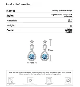Detail of S925 silver infinity earrings with blue sapphire and white gold finish