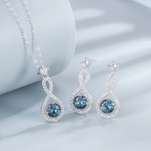 Elegant 925 sterling silver infinity jewelry set with blue round gemstones and white crystals