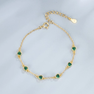 Gold-plated S925 silver bracelet featuring six heart-shaped green emerald cubic zirconia