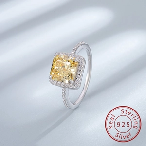 Macro shot of 925 silver ring featuring a cushion-cut yellow stone and halo setting