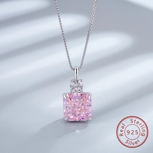 Macro detail of 925 sterling silver necklace with pink square-cut zircon pendant