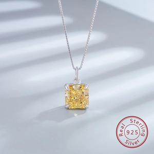 Macro detail of square cut yellow gemstone pendant on 925 sterling silver box chain