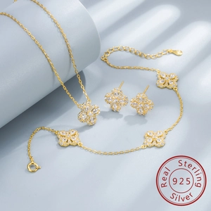 Macro detail of S925 sterling silver clover jewelry set with sparkling zircon inlays