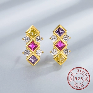 Detail of S925 sterling silver earrings featuring colorful cubic zirconia on silk texture