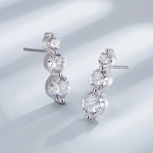 Close-up of S925 sterling silver stamp on three-stone vertical cubic zirconia stud earrings