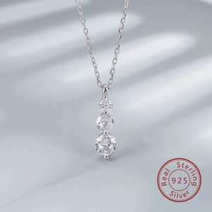 Macro shot of S925 sterling silver necklace with three graduated round clear stones