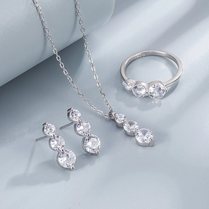 Detailed view of S925 sterling silver stamp on minimalist three-stone jewelry set