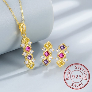Detail of 925 sterling silver jewelry set featuring colorful rhombus gemstones and gold plating