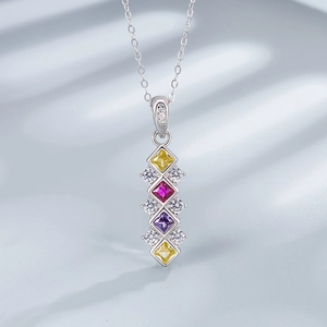 Macro shot of 925 silver necklace with square cut yellow, pink and purple gemstones