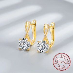 Detail of 925 sterling silver figure-8 earrings with round stones and micro-pave crystals