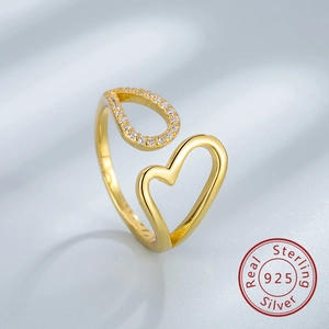Close-up of S925 sterling silver gold ring with hollow heart and zircon teardrop detail