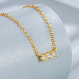 Elegant gold S925 silver necklace featuring three sparkling round-cut zircon stones