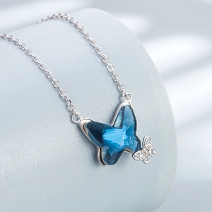 Elegant S925 sterling silver necklace featuring dark blue crystal butterfly and white accents