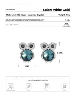 Detail view of S925 silver owl stud earrings with blue Austrian crystal and black eyes