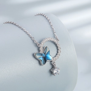 Elegant S925 silver necklace with blue crystal butterfly pendant on a display stand