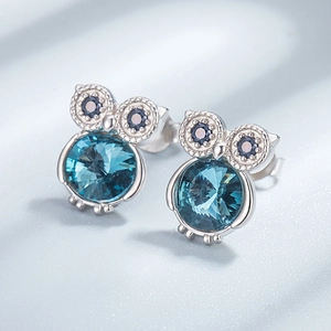 S925 sterling silver owl stud earrings featuring large light blue crystals and dark blue eyes