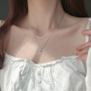 Double-layer S925 sterling silver necklace featuring diamond pendant on female model