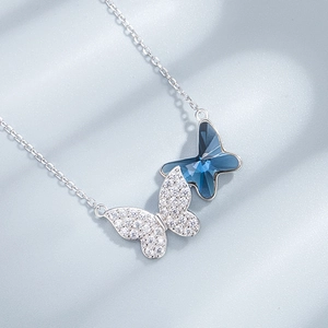 Elegant S925 silver necklace with blue crystal butterfly and pavé stones on grey surface