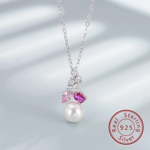 Macro detail of S925 sterling silver necklace with freshwater pearl and pink gemstones
