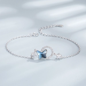 Detailed macro view of S925 silver bracelet featuring blue butterfly crystal charm