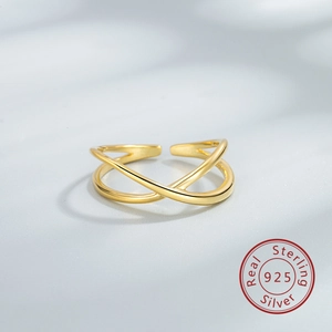 Detailed macro view of S925 sterling silver criss cross ring with shiny golden finish