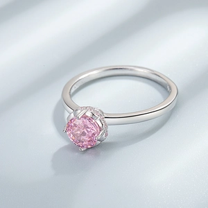 925 sterling silver ring with pink round-cut gemstone and six-prong setting on blue silk