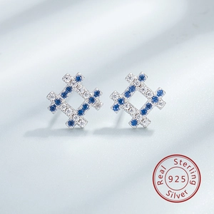Macro shot of S925 sterling silver mesh earrings set with blue and white zircons