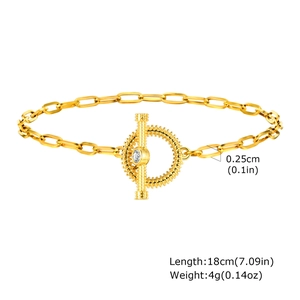 Detail of gold paperclip chain bracelet featuring a zircon-inlaid OT toggle clasp