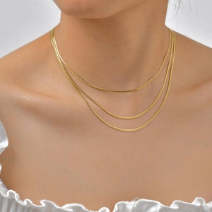 Three-layer 18K gold-plated stainless steel snake chain necklace worn by a model