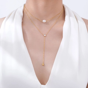 Double-layer gold necklace featuring a baroque pearl, zircon accent, and Y-shaped pendant