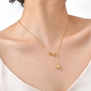 Gold-plated infinity and waterdrop Y-shaped necklace on model showing elegant drape