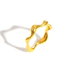 Minimalist irregular wave texture ring in polished gold finish shown from side view